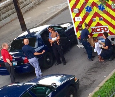 Authorities console children at the scene of a homicide at the 2500 block of Independence this morning. Photo courtesy of Angie Rosete