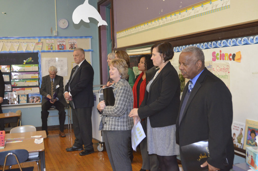 DESE representatives observe students at James Elementary School during their December 1 tour.