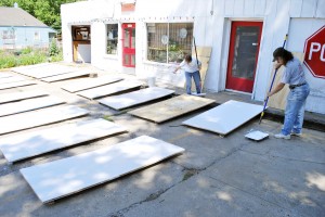 Dorri Partain, left, and Rebecca Koop meet outside of the POTS pottery shop on St. John to paint 29 window boards. The boards will later be painted as individual playing cards and will be installed on an abandoned building at 7th and Indiana. Leslie Collins