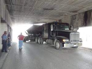 truck w: ppl under bridge