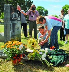 Laid to rest. Eight-year-old Atticus and his mother Jamie Straley carry Ella's ashes to her gravestone. The Straley's visited Ella on a regular basis when she was alive. Leslie Collins 