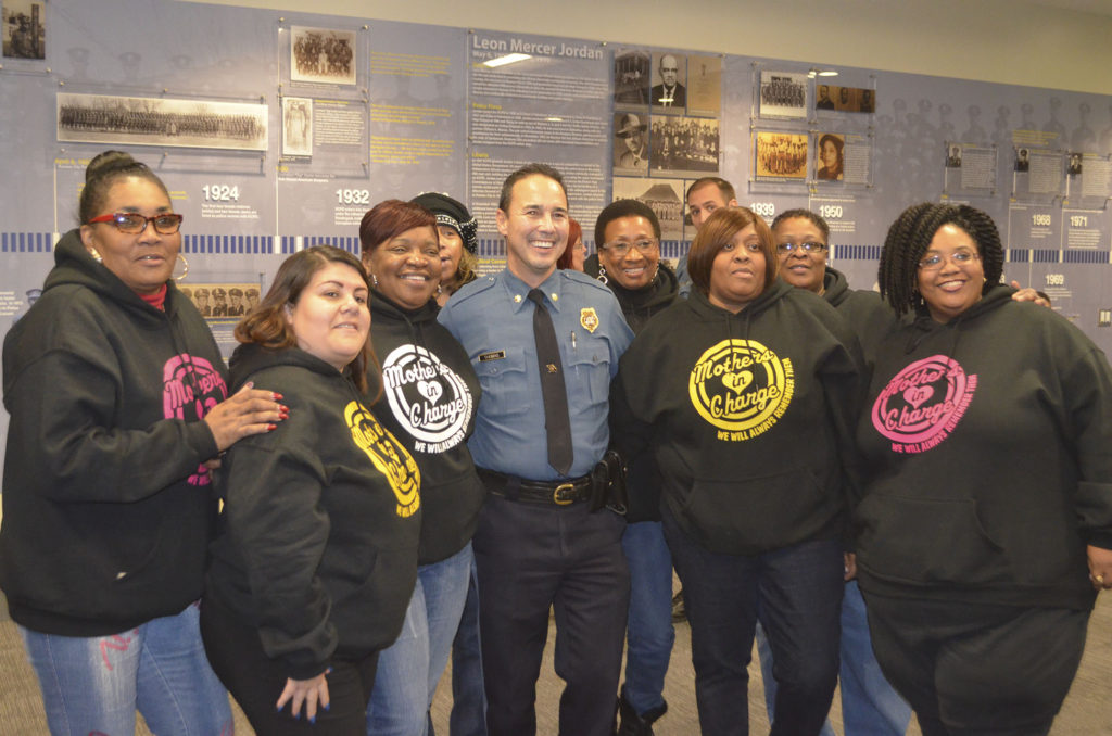 East Patrol's Major Jim Thomas takes a photo with members of the ad-hoc group Mothers in Charge.