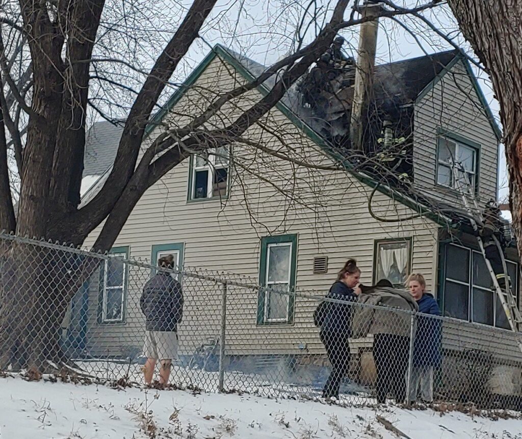 Residents of a home in the 300 block of S. Drury shivered outside in 15 degree temperatures while Kansas City Firefighters worked the roof area around the chimney Thursday afternoon.  Northeast, Kansas City, MO